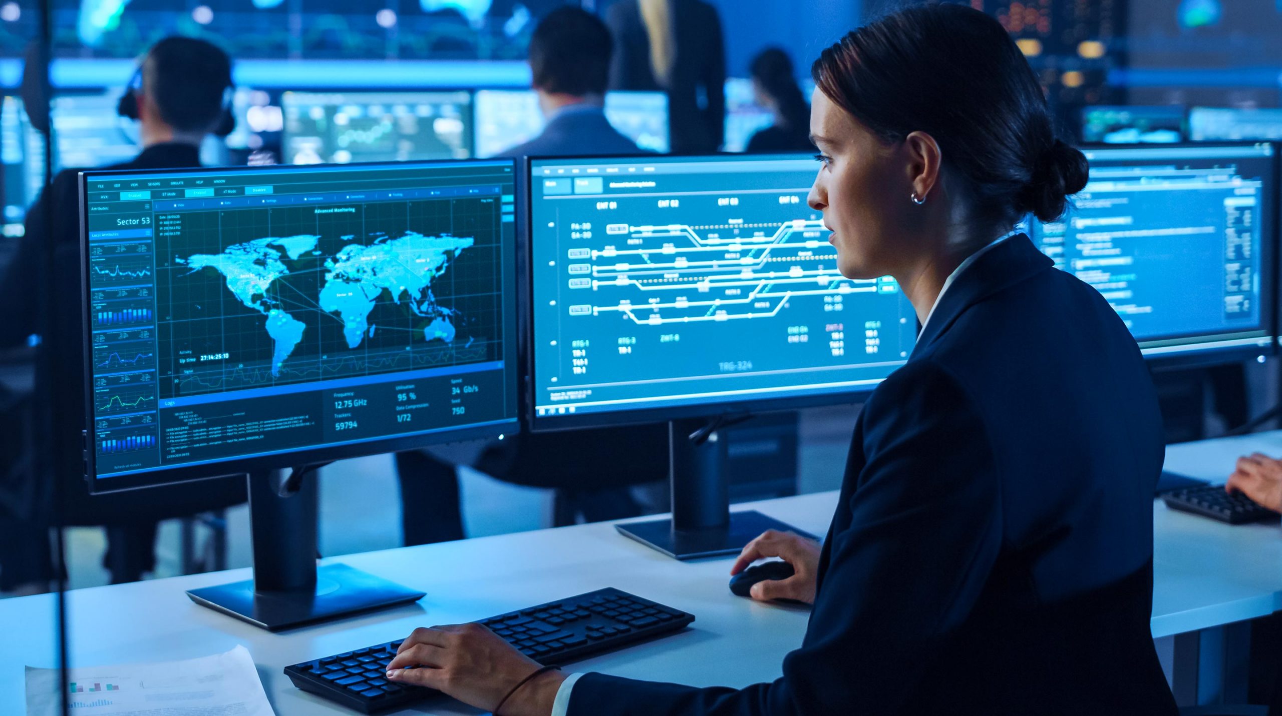 A state-of-the-art corporate network operations center (NOC) displaying real-time server health charts, cloud data traffic visualizations, and proactive cybersecurity monitoring logs.